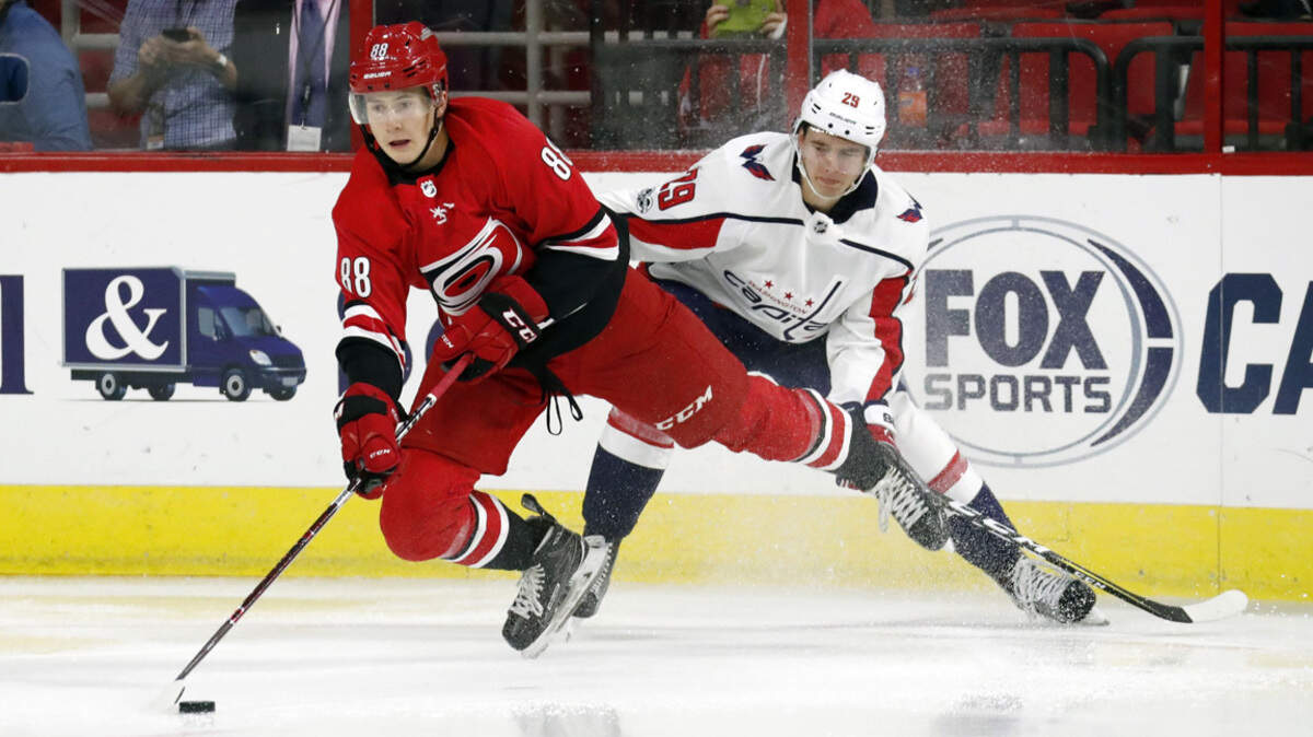 The Canes' Martin Necas (88) battles the Caps' Madison Bowey (22) for the puck during the second period of a preseason NHL game played between the Carolina Hurricanes and the Washington Capitals at PNC Arena in Raleigh, N.C. on Sept. 29, 2017.   