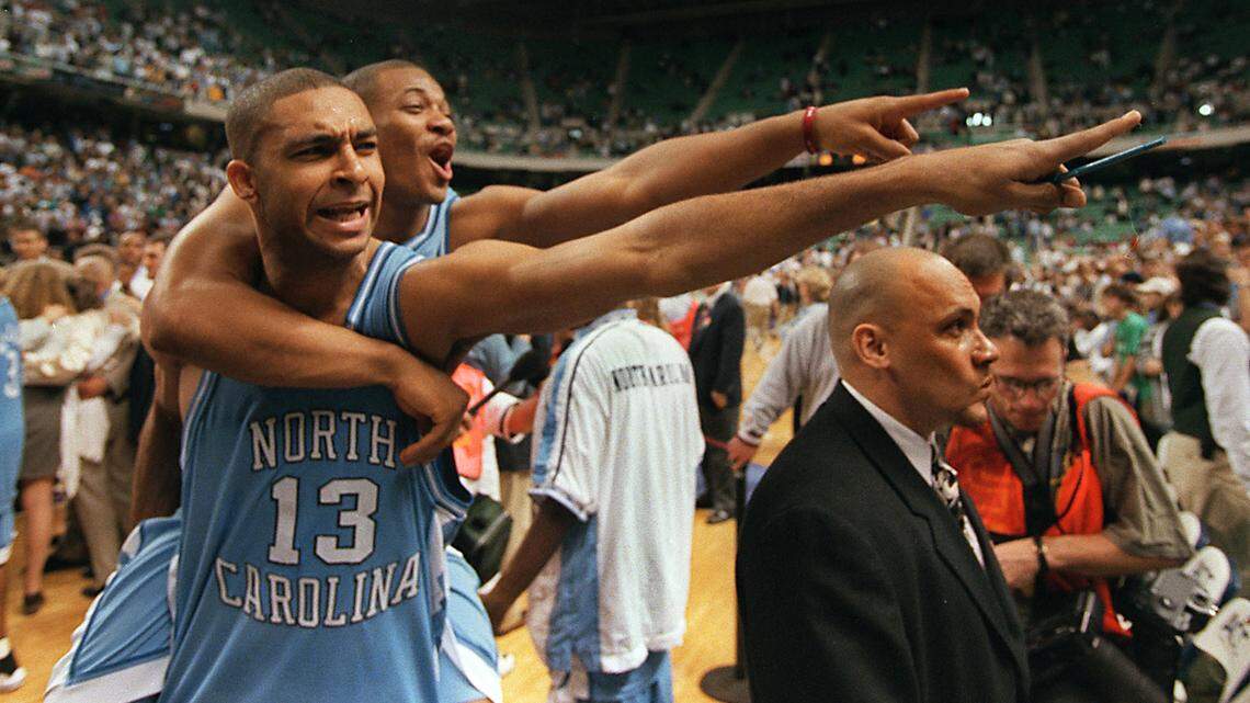 UNC ‘s Ademola Okulaja (13) and Terrence Newby celebrate following UNC’s 1998 ACC Tournament championship win over Duke.