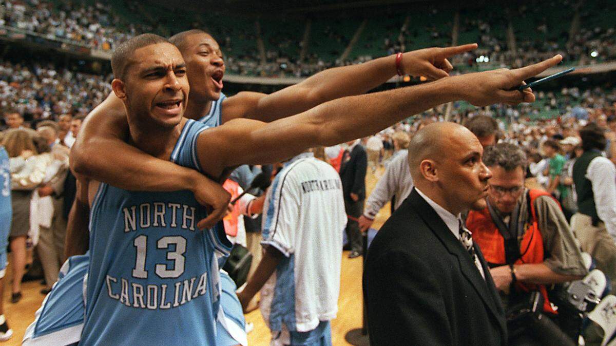UNC ‘s Ademola Okulaja (13) and Terrence Newby celebrate following UNC’s 1998 ACC Tournament championship win over Duke.