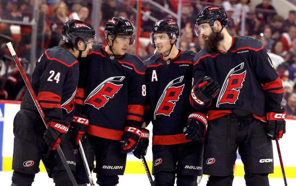 From left, Carolina’s Seth Jarvis (24), Teuvo Teravainen (86), Sebastian Aho (20) and Brent Burns (8) talk during the first period of the Hurricanes game against the Islanders in the first round of the Stanley Cup playoffs at PNC Arena in Raleigh, N.C., Monday, April 22, 2024.