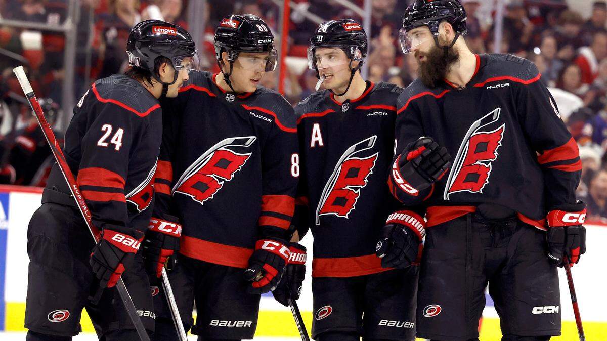 From left, Carolina’s Seth Jarvis (24), Teuvo Teravainen (86), Sebastian Aho (20) and Brent Burns (8) talk during the first period of the Hurricanes game against the Islanders in the first round of the Stanley Cup playoffs at PNC Arena in Raleigh, N.C., Monday, April 22, 2024.