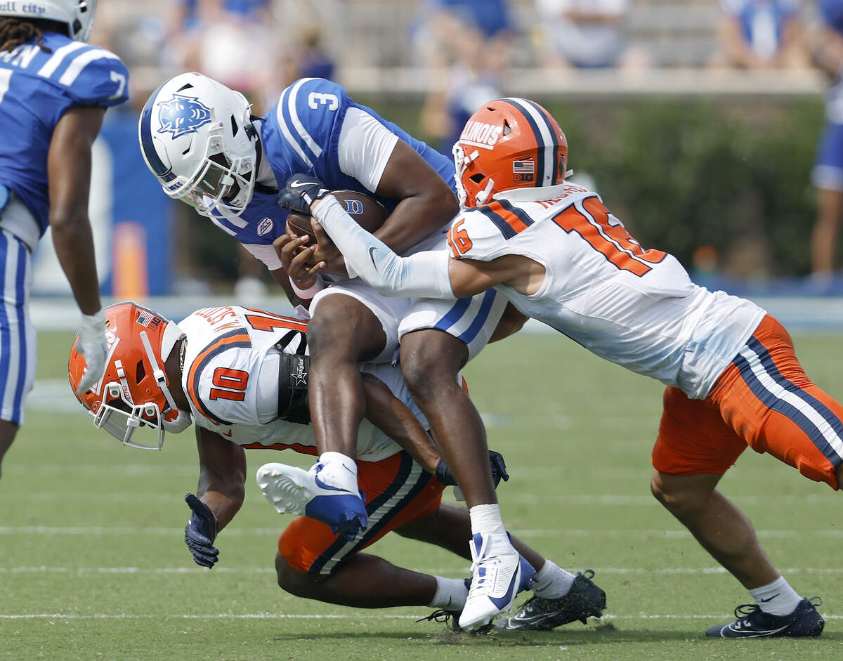 Duke quarterback Henry Belin IV is brought down by Illinois’ Miles Scott and Tanner Heckel during the second half of the Blue Devils’ 45-19 loss on Saturday, Sept. 6, 2025, at Wallace Wade Stadium in Durham, N.C.