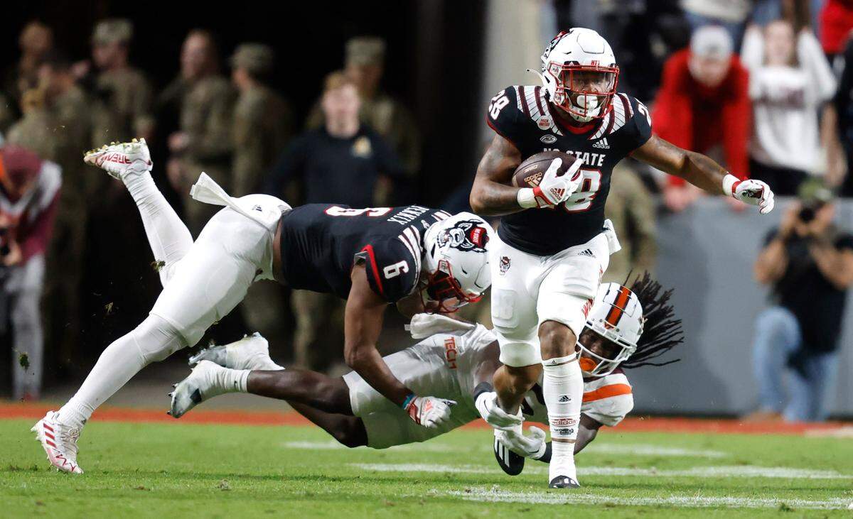 N.C. State running back Demarcus Jones II (28) breaks free from a Virginia Tech defender during the first half of N.C. State’s game against Virginia Tech at Carter-Finley Stadium in Raleigh, N.C., Thursday, Oct. 27, 2022.