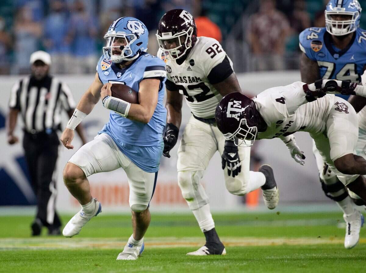 North Carolina quarterback Sam Howell (7) carries the ball for 15 yards and a first down in the second quarter against Texas A&M in the Capital One Orange Bowl on Saturday, January 2, 2021in Miami Gardens, Florida.