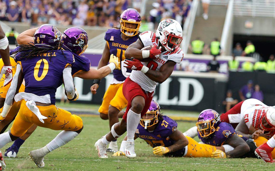 N.C. State running back Demie Sumo-Karngbaye (0) escapes multiple East Carolina defenders during a run in the second half of N.C. State’s 21-20 victory over ECU at Dowdy-Ficklen Stadium in Greenville, N.C., Saturday, Sept. 3, 2022.