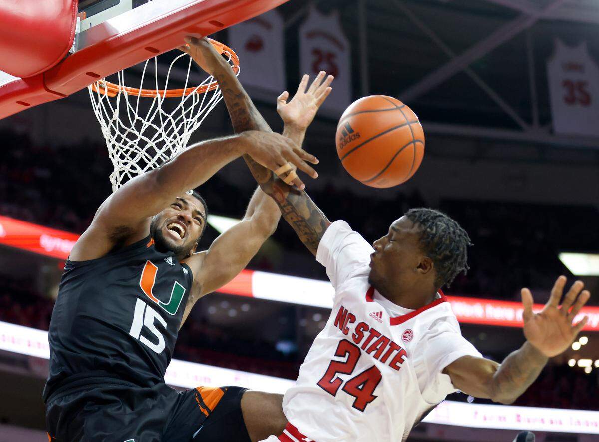 Miami’s Norchad Omier blocks a shot by N.C. State’s Ernest Ross during the second half of a men’s basketball game at PNC Arena on Saturday, Jan. 14, 2023, in Raleigh, N.C.
