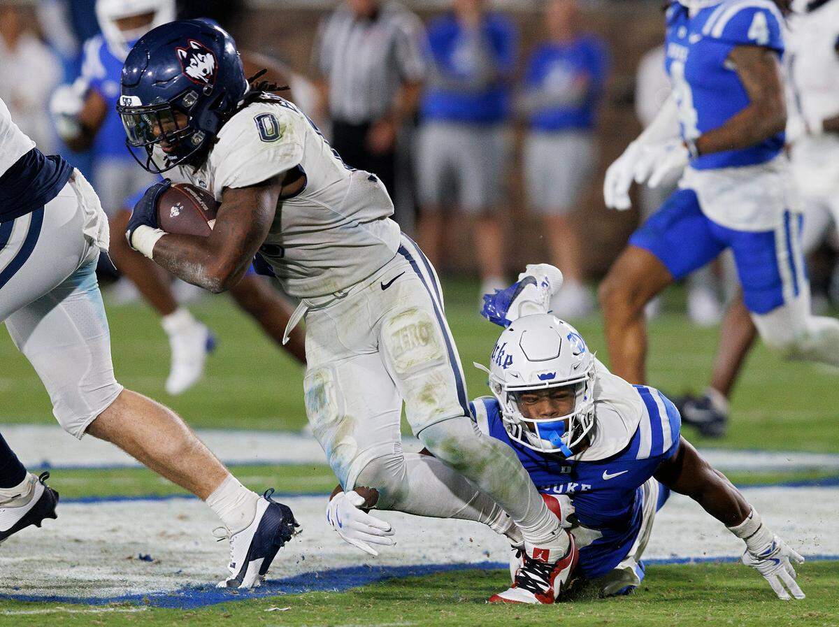 Duke’s Terry Moore dives after Connecticut’s Cam Edwards during the second half of the Blue Devils’ 26-61 win on Saturday, Sept. 14, 2024, at Wallace Wade Stadium in Durham, N.C.