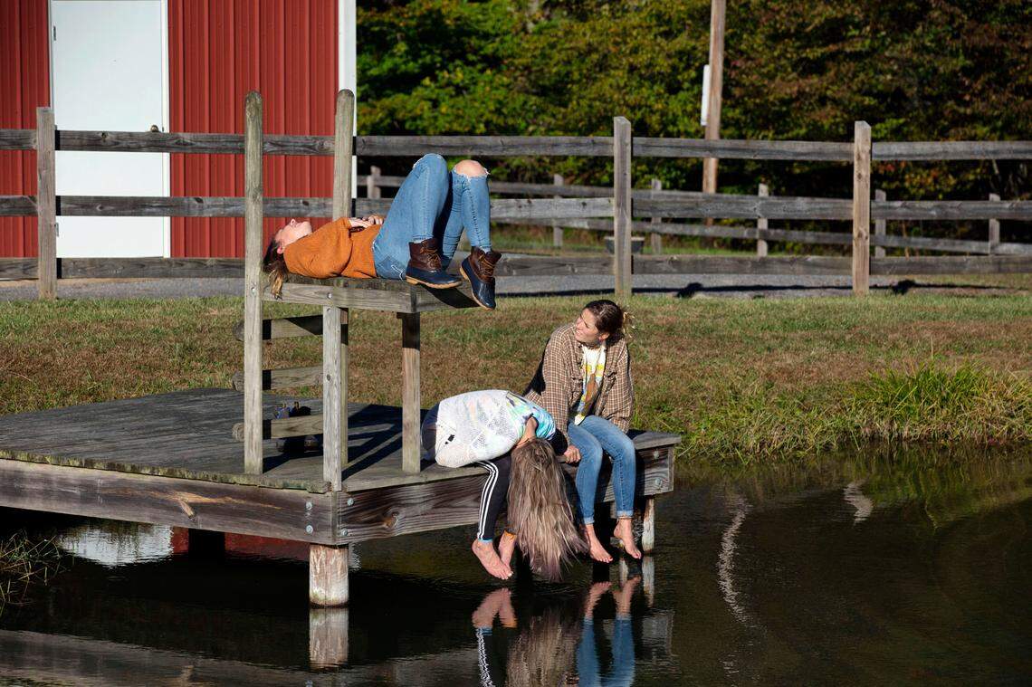 Juliet and Iris Howell pass the afternoon sitting the dock with Riley’s longtime girlfriend, Lauren Westmoreland, on the Howells’ property, Sunday October 20, 2019.