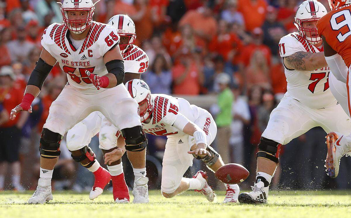 N.C. State quarterback Ryan Finley (15) tries to recover a bad snap during the first half of N.C. State’s game against Clemson at Memorial Stadium in Clemson, S.C., Saturday, Oct. 20, 2018. Clemson recovered the football. 