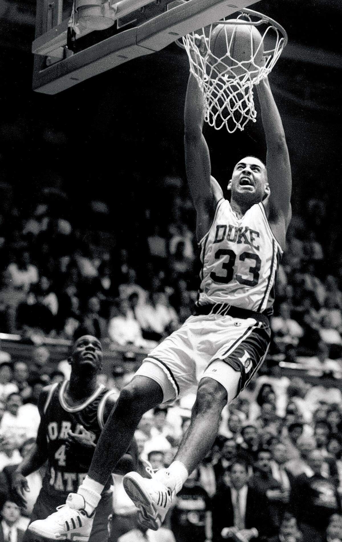 Duke’s Grant Hill dunks against Florida State’s Chuck Graham on June 30, 2002.
