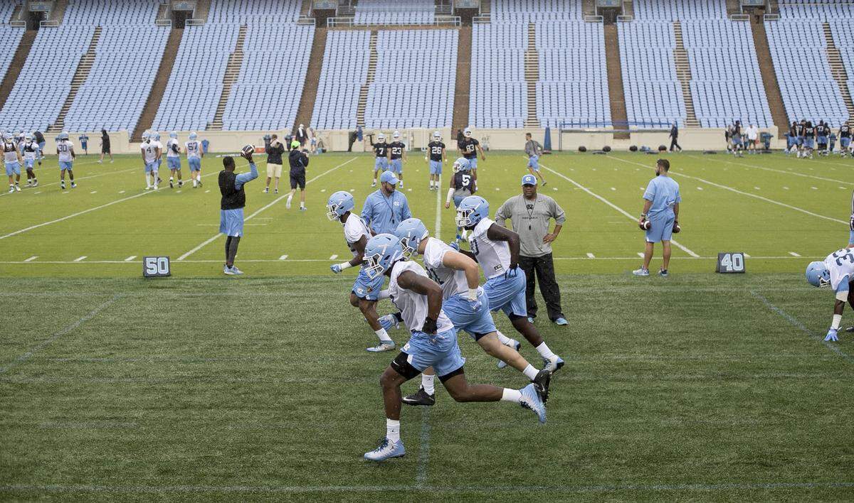 North Carolina freshman defensive end Chris Collins (17) runs sprints with teammates during the Tar Heels’ first practice of football camp on Friday, August 3, 2018 at Kenan Stadium in Chapel Hill, N.C. New blue seats have been installed in Kenan Stadium replacing the old metal bleachers.