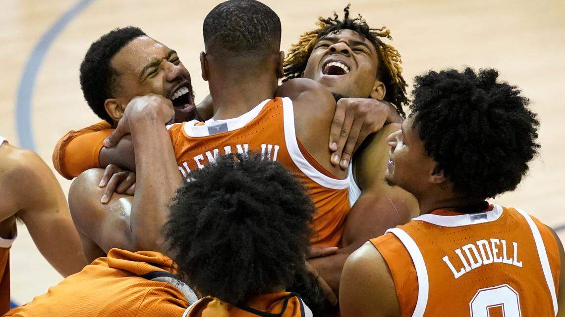 Texas guard Matt Coleman III (2) is hugged by teammates after Texas beat North Carolina 69-67 to win the NCAA college basketball game for the championship of the Maui Invitational, Wednesday, Dec. 2, 2020, in Asheville, N.C. Coleman was the MVP with the winning basket and high score of 22 points.