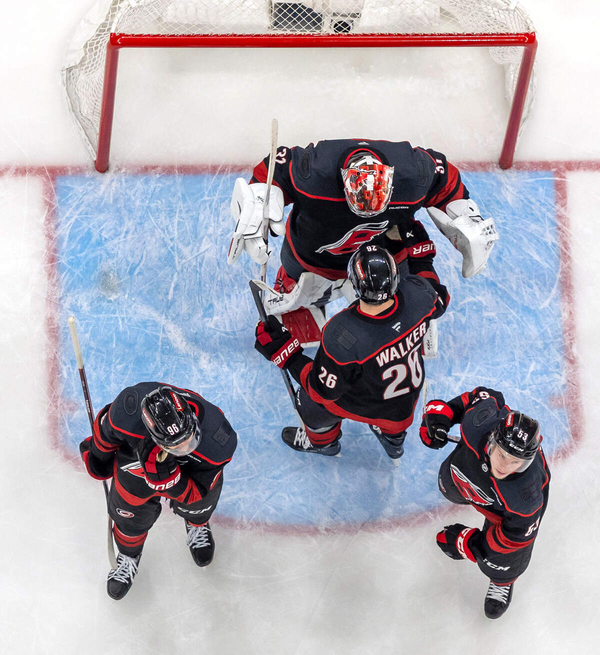 Carolina Hurricanes defenseman Sean Walker (26) congratulates goalie Frederik Andersen (31) as they celebrate their 5-2 victory over the Washington Capitals in Game 4 of their series on Monday, May 12, 2025 at Lenovo Center in Raleigh, N.C.
