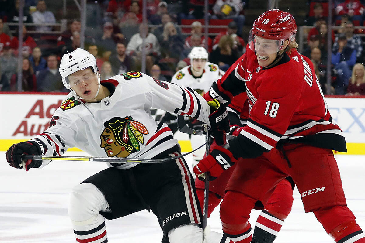 Carolina Hurricanes’ Ryan Dzingel (18) collides with Chicago Blackhawks’ Olli Maatta (6), of Finland, during the second period of an NHL hockey game, in Raleigh, N.C., Saturday, Oct. 26, 2019. (AP Photo/Karl B DeBlaker)
