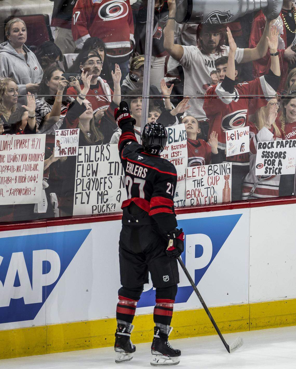 Carolina Hurricanes left wing Nikolaj Ehlers (27) tosses a puck to fans fowling the pre-game warm ups ahead of their game against Ottawa on Saturday, April 18, 2026 at Lenovo Center in Raleigh, N.C. 