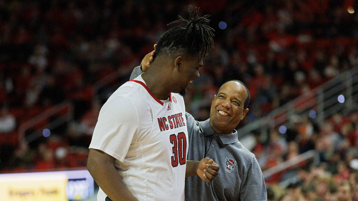 N.C. State head coach Kevin Keatts smiles as DJ Burns Jr. heads to the bench late in the second half of the Wolfpack’s 76-60 win over Virginia on Saturday, Jan. 6, 2024, at PNC Arena in Raleigh, N.C.