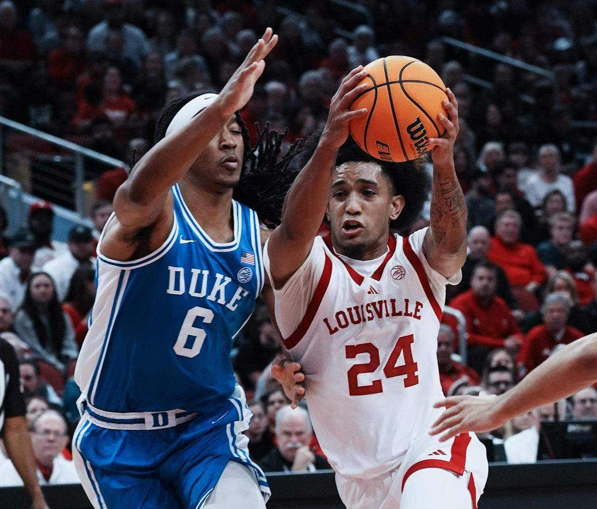 Louisville’s Chucky Hepburn (24) drives against Duke’ s Maliq Brown (6) during their game at the KFC Yum! Center in Louisville, Ky. on Dec. 8, 2024.