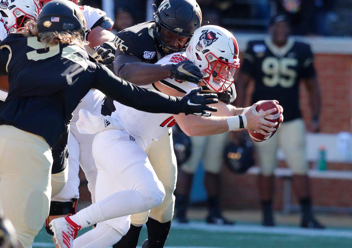 N.C. State quarterback Devin Leary (13) stretches for extra yards during the second half of Wake Forest’s 44-10 victory over N.C. State at BB&T Field in Winston-Salem, N.C., Saturday, Nov. 2, 2019.