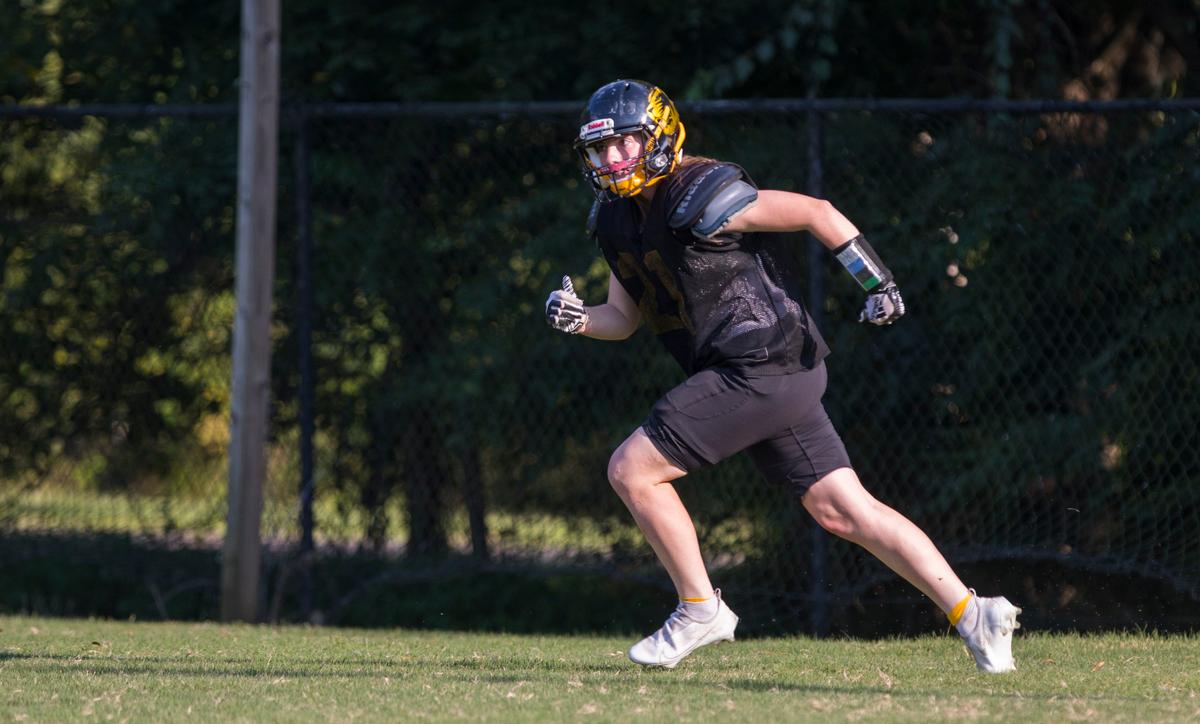 Chapel Hill High School varsity football player Brooklyn Harker runs during a play while at practice in Chapel Hill, N.C. on Tuesday, Sept. 14, 2021.
