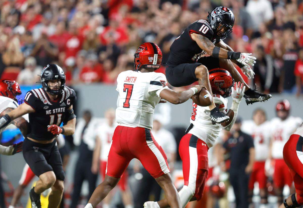 N.C. State’s Tanner Ingle (10) tries to get by Texas Tech’s Tahj Brooks (28) to pressure Texas Tech quarterback Donovan Smith (7) during the second half of N.C. State’s 27-14 victory over Texas Tech at Carter-Finley Stadium in Raleigh, N.C., Saturday, Sept. 17, 2022.