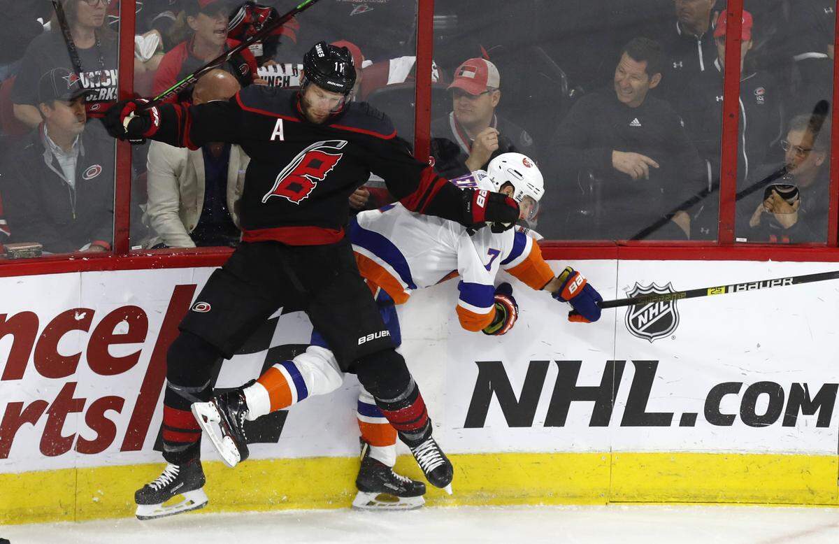 Carolina’s Jordan Staal (11) hits New York’s Jordan Eberle (7) during the first period of the Carolina Hurricanes’ game against the New York Islanders at PNC Arena in Raleigh Wednesday, May 1, 2019.