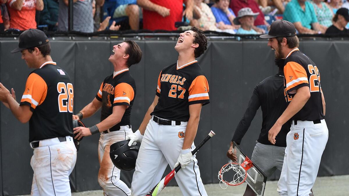 Fuquay-Varina’s Drew Beauchesne (27) reacts after Parker McGraw’s three run homer in the third inning. The Fuquay-Varina Bengals and the Ronald Reagan Raiders met in the NCHSAA 4A baseball final Series in Burlington NC on June 26, 2021.