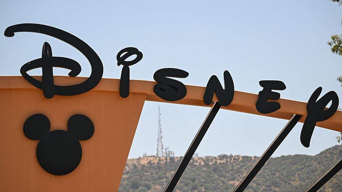 Signage is displayed at the entrance to The Walt Disney Studios in Burbank, California on June 2, 2025. On June 2, Disney announced it is laying off hundreds of workers in film, TV, and finance to cut costs and focus more on streaming. (Photo by Patrick T. Fallon / AFP) (Photo by PATRICK T. FALLON/AFP via Getty Images)          