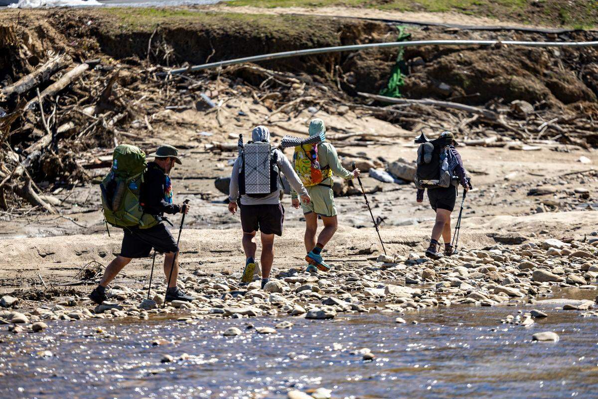 Appalachian Trail hikers continue on their journey after being ferried across the Nolichucky River near the former site of the Chestoa Pike Bridge.