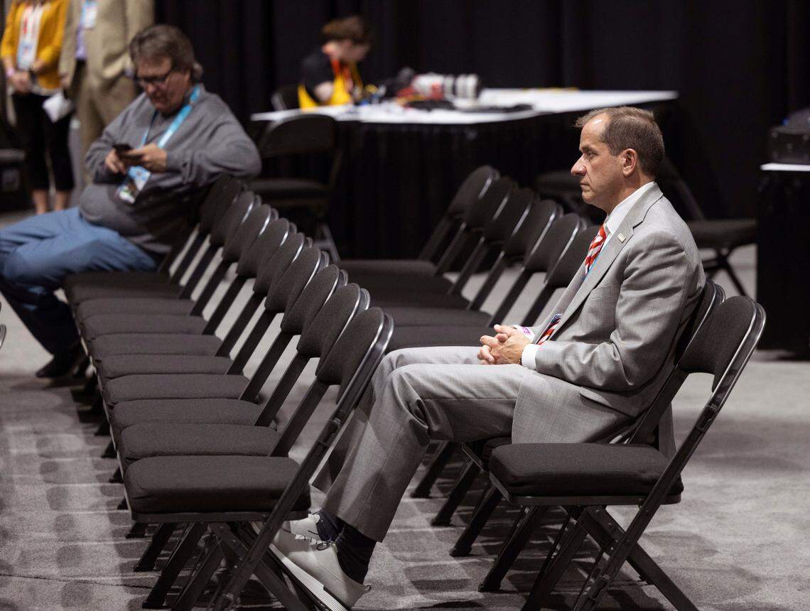 ACC Commissioner Jim Phillips watches N.C. State coach Kevin Keatts, during his post game press conference following the Wolfpack’s loss to Purdue in the NCAA Final Four National Semifinal game on Saturday, April 6, 2024 at State Farm Stadium in Glendale, AZ.