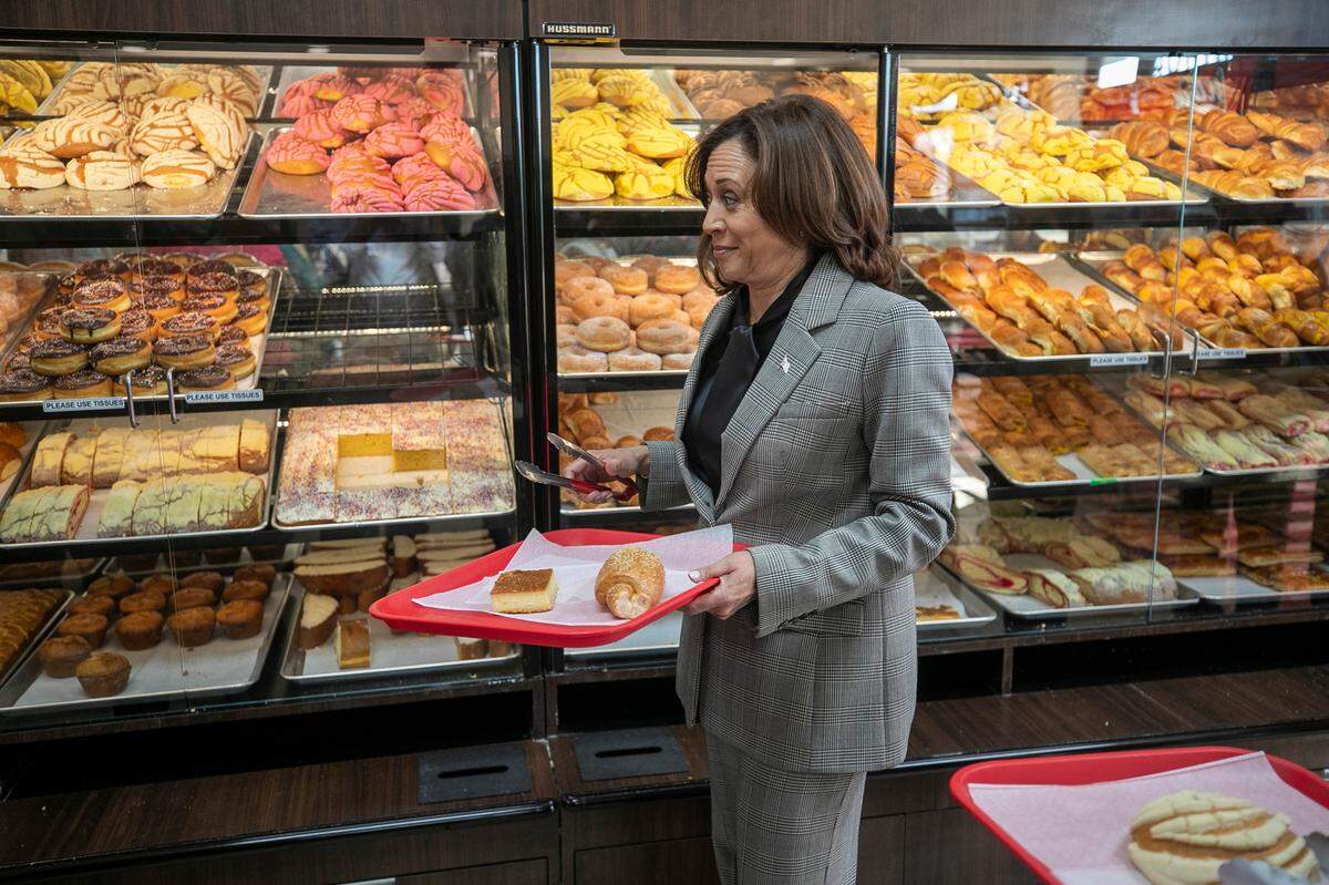 Vice President Kamala Harris fills a tray with baked goods during a visit to Panaderia Artisanal, a Latina-owned bakery on Monday, January 30, 2023 in Raleigh, N.C.
