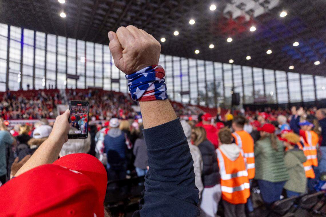 Supporters of Republican presidential nominee and former President Donald Trump cheer after the National Anthem during a campaign rally at Dorton Arena in Raleigh on Monday, Nov. 4, 2024, one day before Election Day.