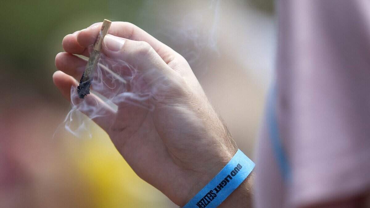 A festival goer smokes marijuana at Lollapalooza on July 29, 2021, in Chicago. 