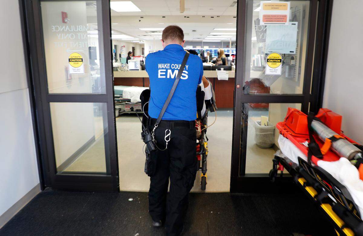 A patient is brought into the emergency department at UNC REX Hospital in Raleigh, N.C., Friday, October 1, 2021.
