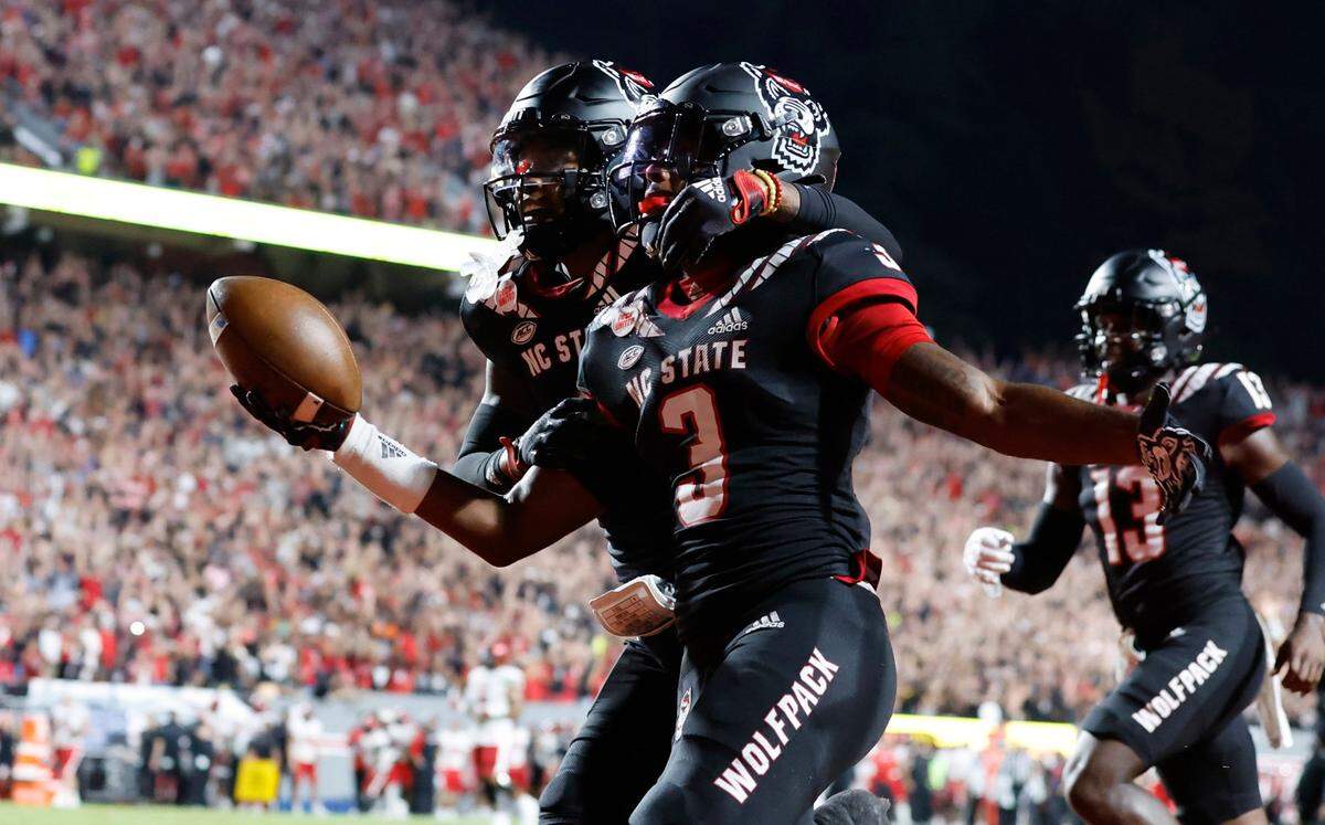 N.C. States Cyrus Fagan (4) celebrates with Aydan White (3) after White returned his interception 84-yards for a touchdown during the first half of N.C. States game against Texas Tech at Carter-Finley Stadium in Raleigh, N.C., Saturday, Sept. 17, 2022.