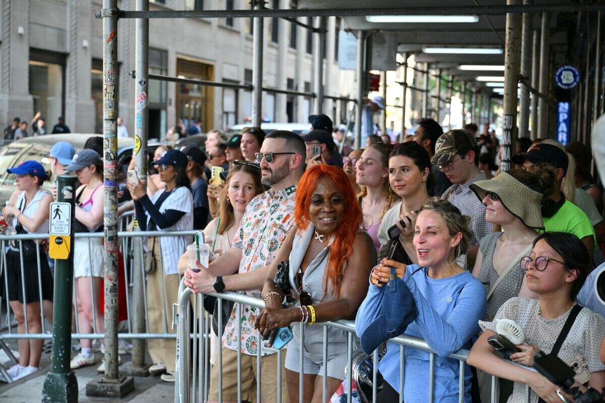 Fans stand outside Madison Square Garden, the reported venue for the wedding celebrations of pop singer Taylor Swift and pro-athlete Travis Kelce, in New York City on July 3, 2026. Swift and Kelce's official wedding plans are tightly under wraps, but New York is bracing to host the celebrity marriage of the year this week at Madison Square Garden. The wedding will reportedly take place Friday with a star-studded guest list of around 1,000, including models Gigi Hadid and Cara Delevingne, singer Selena Gomez, and actress Zoe Kravitz -- all known to be close Swift pals -- and Kelce's Kansas City Chiefs teammates.