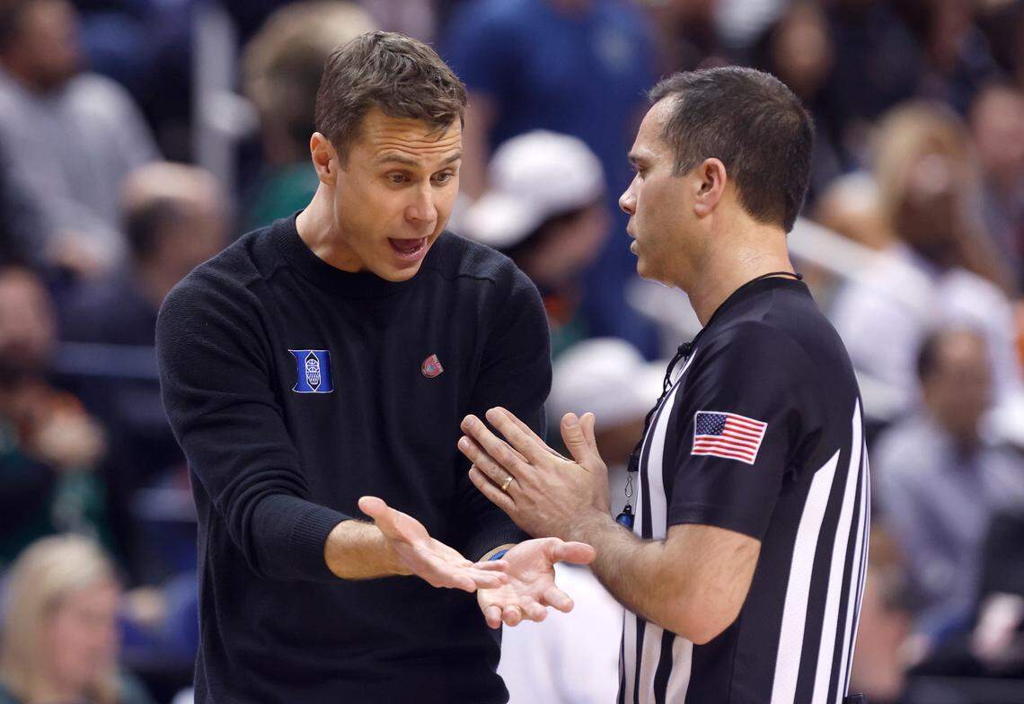 Duke head coach Jon Scheyer protests a call with official A.J. Desai during the second half of Duke’s 85-78 victory over Miami in the semifinals of the ACC Men’s Basketball Tournament in Greensboro, N.C., Friday, March 10, 2023.