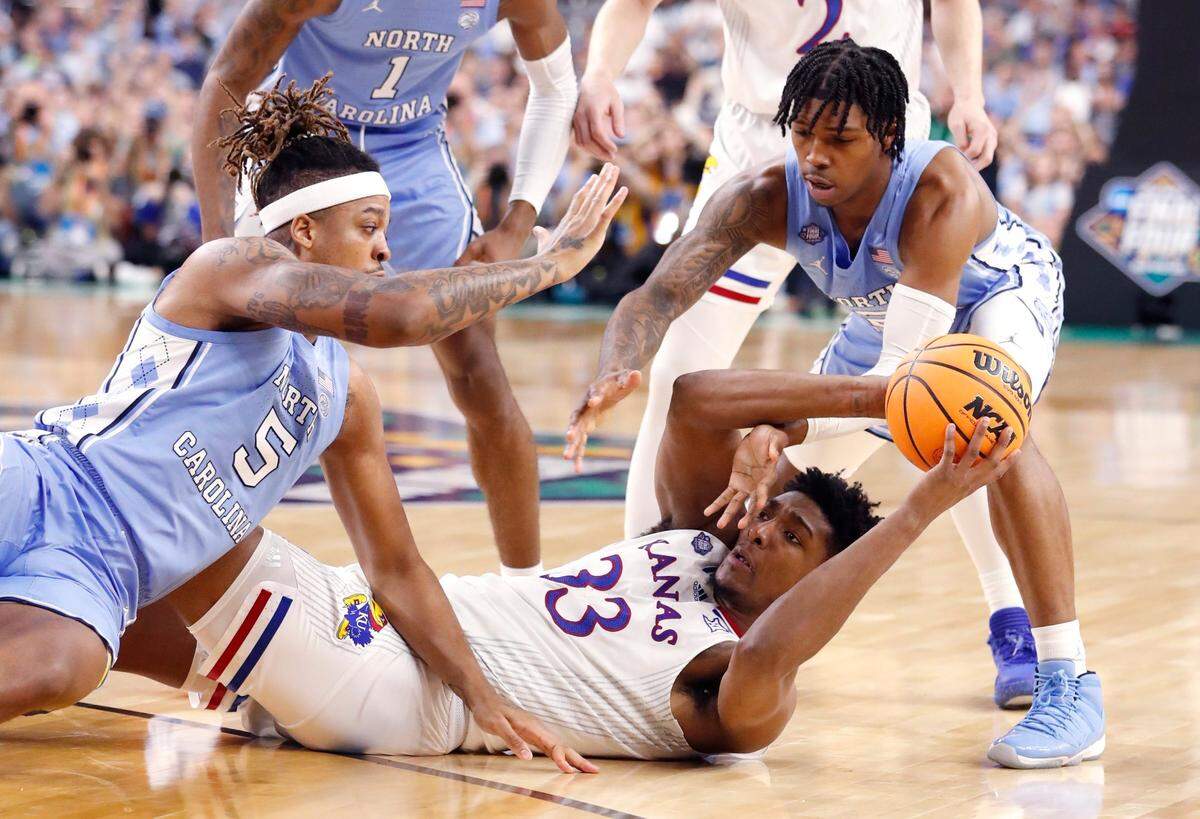 North Carolina’s Armando Bacot (5) and Caleb Love (2) pressure Kansas’ David McCormack (33) during the first half of UNCs game against Kansas in the NCAA Mens National Championship at the Caesars Superdome in New Orleans, La., Monday, April 4, 2022.
