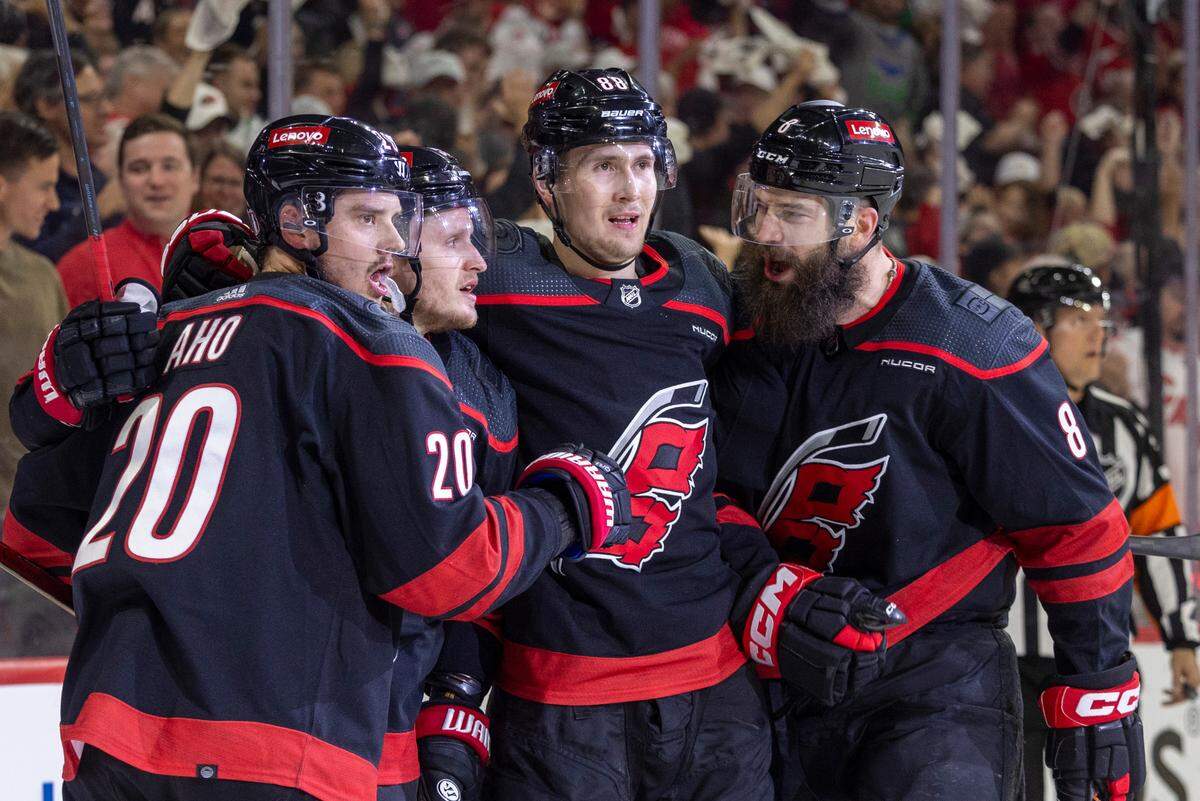 Carolina Hurricanes center Sebastian Aho (20) celebrates with teammates Jake Guentzel (59), Martin Necas (88) and Brent Burns (8) after scoring in the first period on New York Rangers goaltender Igor Shesterkin (31) during Game 4 in the second round of the 2024 Stanley Cup playoffs on Saturday, May 11, 2024 at PNC Arena, in Raleigh N.C.