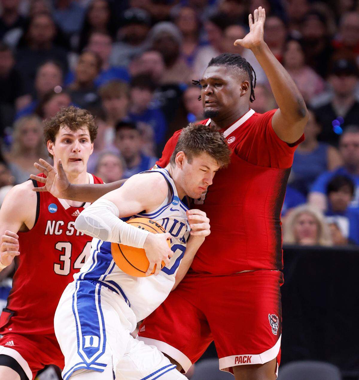 N.C. State’s DJ Burns Jr. (30) defends Duke’s Kyle Filipowski (30) during the second half of N.C. State’s 76-64 victory over Duke in their NCAA Tournament Elite Eight matchup at the American Airlines Center in Dallas, Texas, Sunday, March 31, 2024.