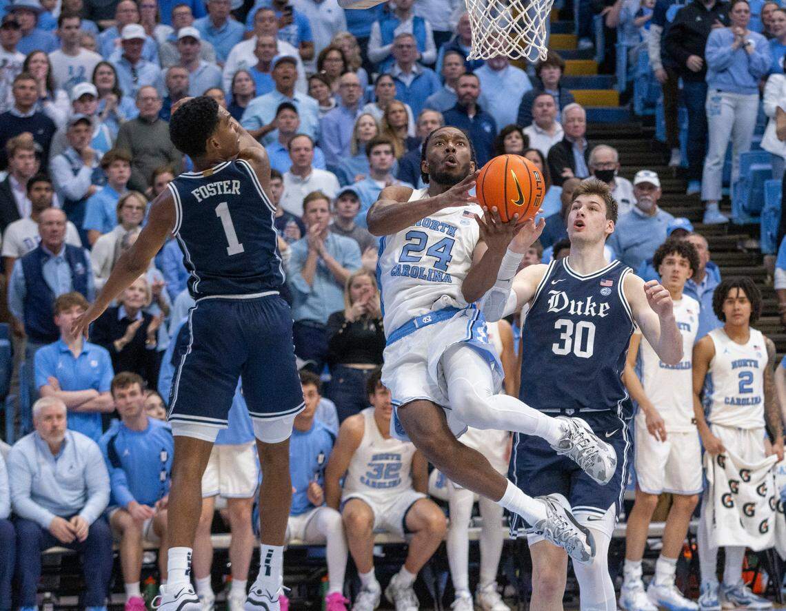 North Carolina’s Jae’Lyn Withers (24) drives to the basket against Duke’s Caleb Foster (1) and Kyle Filipowski (30) in the second half on Saturday, February, 3, 2024 at the Dean E. Smith Center in Chapel Hill, N.C.