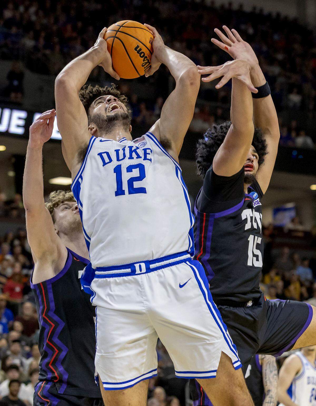 Duke forward Cameron Boozer (12) drives to the basket against TCU forward David Punch (15) in the first half on Saturday, March 21, 2026, during the second round of the NCAA Tournament at Bon Secours Arena in Greenville, S.C.