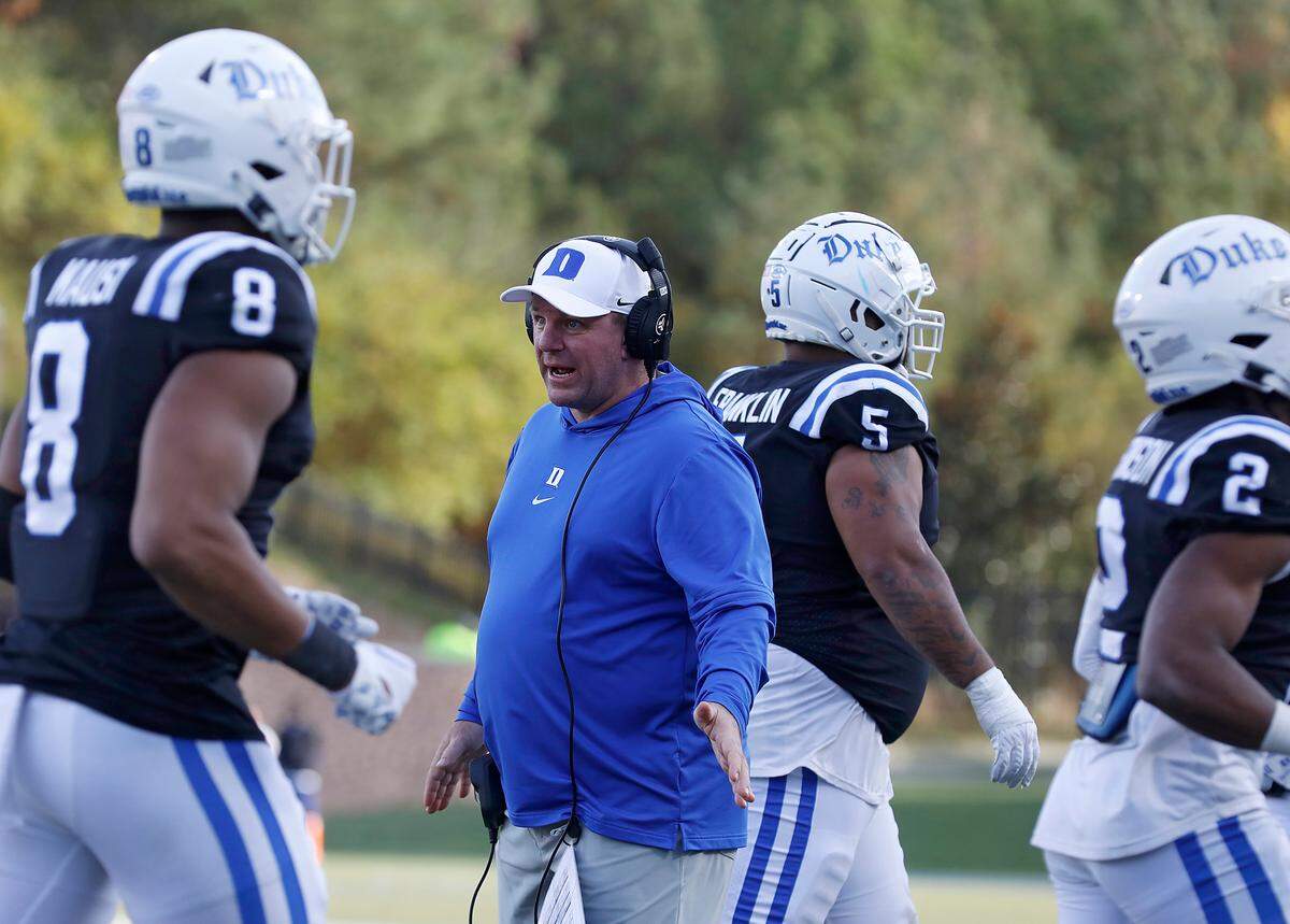Duke head coach Mike Elko high fives players during the second half of the Blue Devils’ 30-19 win over Pittsburgh on Saturday, Nov. 25, 2023, at Wallace Wade Stadium in Durham, N.C.