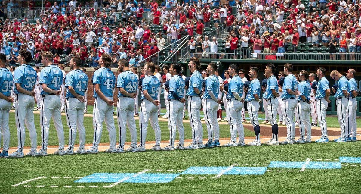 The North Carolina Tar Heels stand along the third base line for the National Anthem prior to their game against Arkansas in game two of their NCAA Super Regional series on Sunday, June 12, 2022 at Boshamer Stadium in Chapel Hill, N.C.