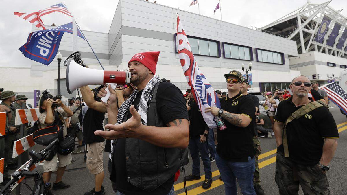 A group from the Proud Boys confront anti-President Donald Trump protestors during a rally Tuesday, June 18, 2019, in Orlando.