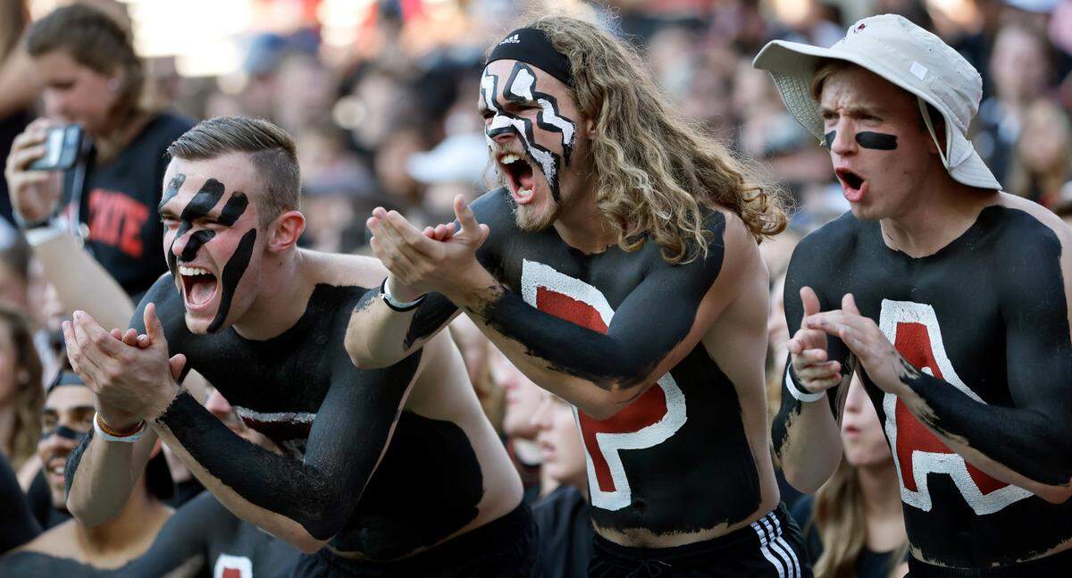From left, N.C. State students Logan Luparello, Matt Strickland and David Teague cheer before the Wolfpack’s game against Texas Tech at Carter-Finley Stadium in Raleigh, N.C., Saturday, Sept. 17, 2022.