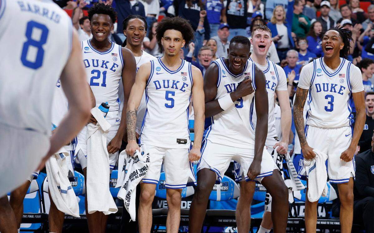 The Duke bench, including Patrick Ngongba II (21), Maliq Brown, Tyrese Proctor (5), Khaman Maluach (9), Cooper Flagg (2) and Isaiah Evans (3) celebrate after Darren Harris (8) slammed in two during the second half of Duke’s 93-49 victory over Mount St. Mary’s in the first round of the 2025 NCAA Men’s Basketball Tournament at the Lenovo Center in Raleigh, N.C., Friday, March 21, 2025.
