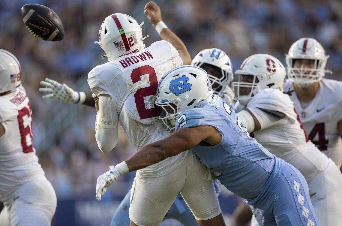 North Carolina linebacker Andrew Simpson (2) forces a fumble by Stanford quarterback Elijah Brown (2) in the first quarter on Saturday, November 8, 2025 at Kenan Stadium in Chapel Hill, N.C.