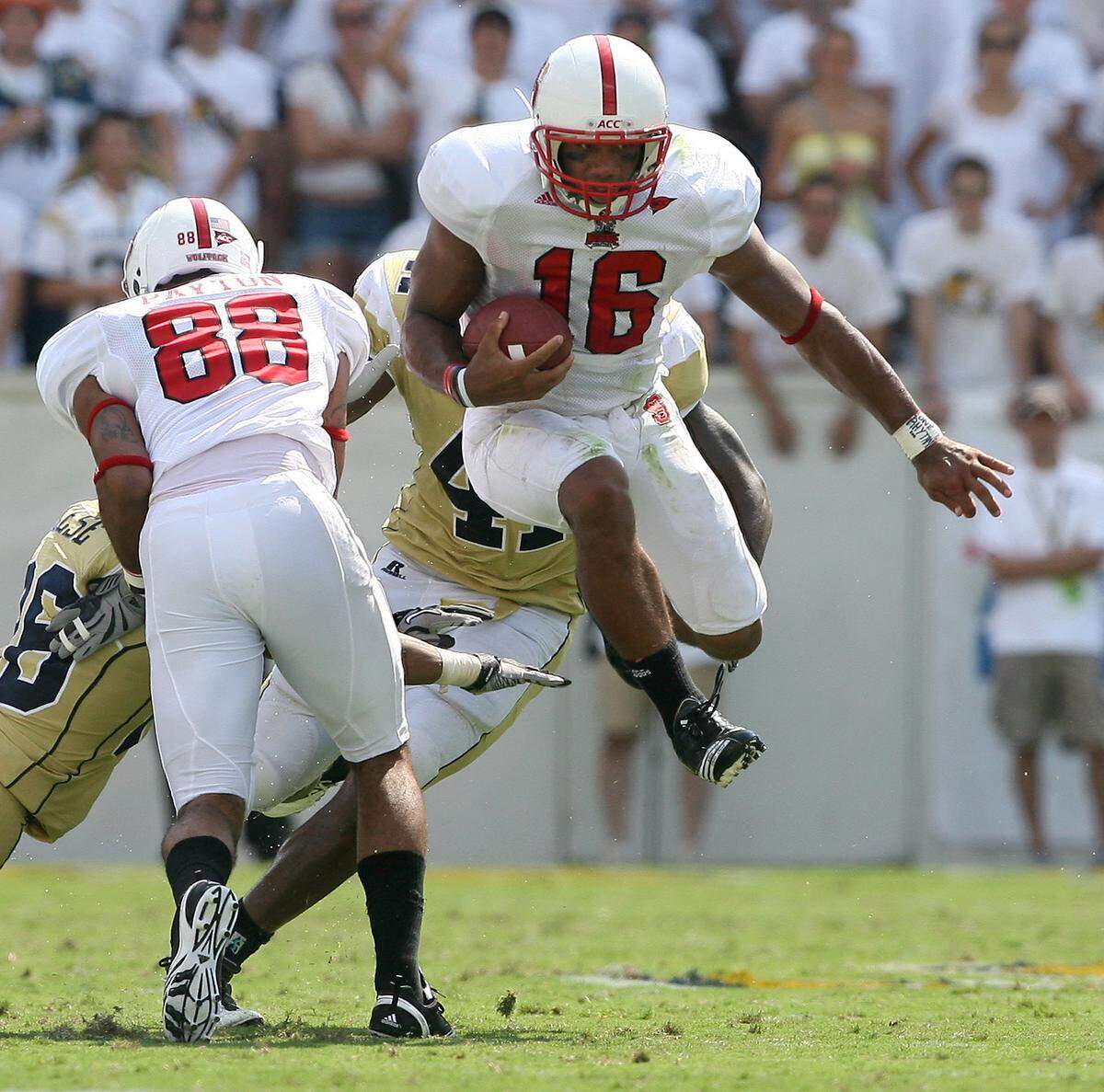 N.C. State’s Russell Wilson (16) avoids Georgia Tech defenders as he gains yards during the Wolfpack’s victory over the Yellow Jackets in Atlanta in 2010.