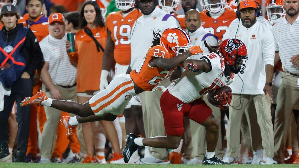 N.C. State wide receiver Keyon Lesane (15) tries to escape from Clemson cornerback Toriano Pride (23) during the second half of Clemson’s 30-20 victory over N.C. State at Memorial Stadium in Clemson, S.C., Saturday, Oct. 1, 2022.
