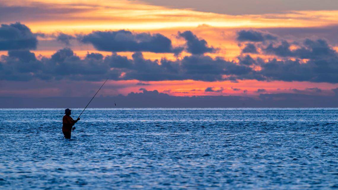 A fisherman tries his luck in the Pamlico Sound at Kite Point on Tuesday, June 29, 2021 near Buxton, N.C.